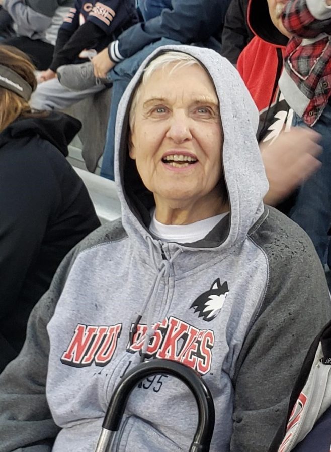 Joyce DeFauw sitting at a sports game. At 89 years old, she is NIUs oldest student. 
