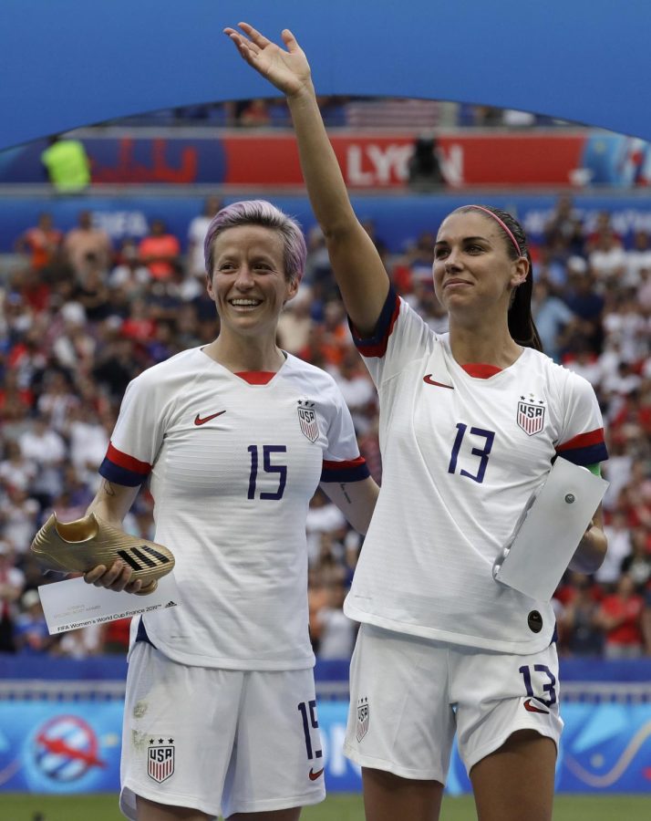 AP FILE - United States Megan Rapinoe, left, and her teammate Alex Morgan, right, react after winning the Womens World Cup final soccer match between the United States and The Netherlands at the Stade de Lyon in Decines, outside Lyon, France, Sunday, July 7, 2019. U.S. women soccer players reached a landmark agreement with the sport’s American governing body to end a six-year legal battle over equal pay, a deal in which they are promised $24 million plus bonuses that match those of the men. 