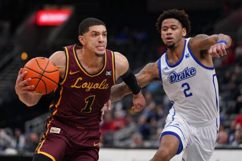 Loyola of Chicagos Lucas Williamson (left) heads to the basket as Drakes Tremell Murphy (right) defends during the second half of an NCAA college basketball game in the championship of the Missouri Valley Conference tournament Sunday, March 6 in St. Louis. (AP Photo/Jeff Roberson)
