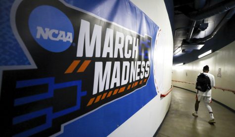 Arizona guard Shaina Pellington walks past an NCAA March Madness sign in the hallways of McKale Center before Arizonas game against UNLV in the first round of the NCAA womens college basketball tournament March 19 in Tucson, Arizona. (Rebecca Sasnett/Arizona Daily Star via AP)