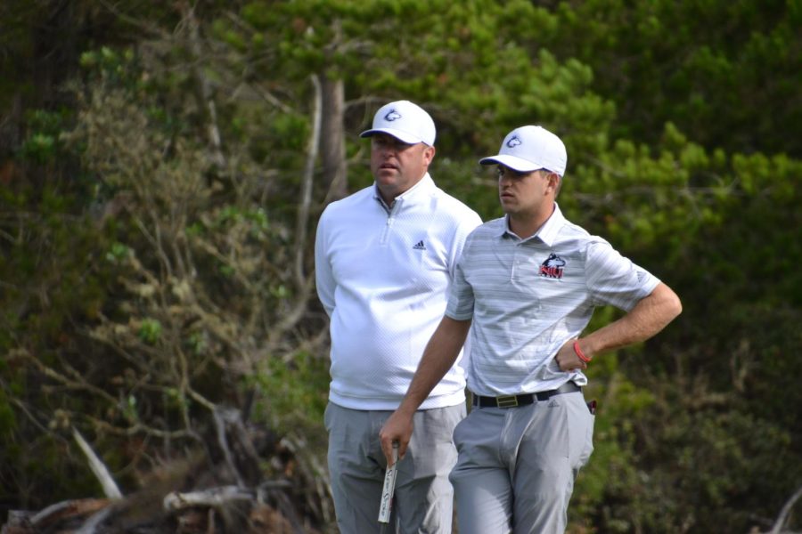 Mens head golf coach John Carlson (Left) talks through a shot with then-senior Tommy Dunsire during the first round of the 2021 Saint Marys Invitational at Poppy Hills Golf Course in Pebble Beach, California. (Wes Sanderson | Northern Star)