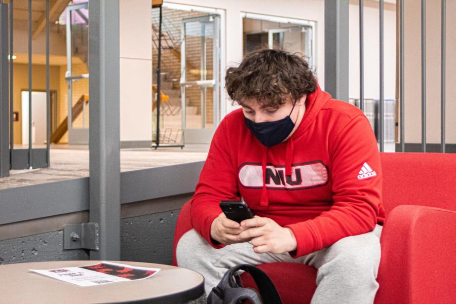 Freshman engineering major Aaron Dennis wears his mask at a lounging area inside the Holmes Student Center on Tuesday, March 22nd. Masks were made optional at NIU on Feb. 28th., nearly two years after COVID-19 first started.