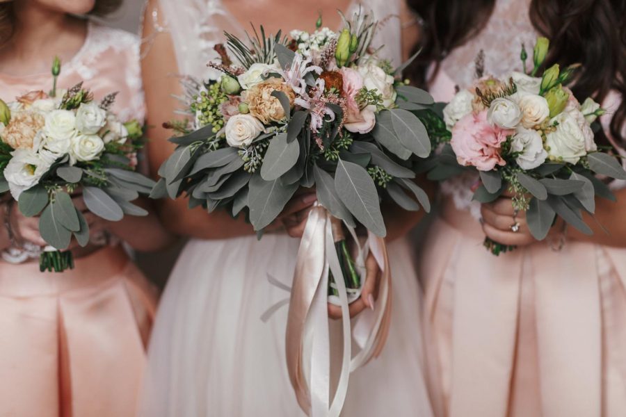 A bridal party poses with flowers. For columnist Angelina, being maid of honor is an experience that she will always cherish. 