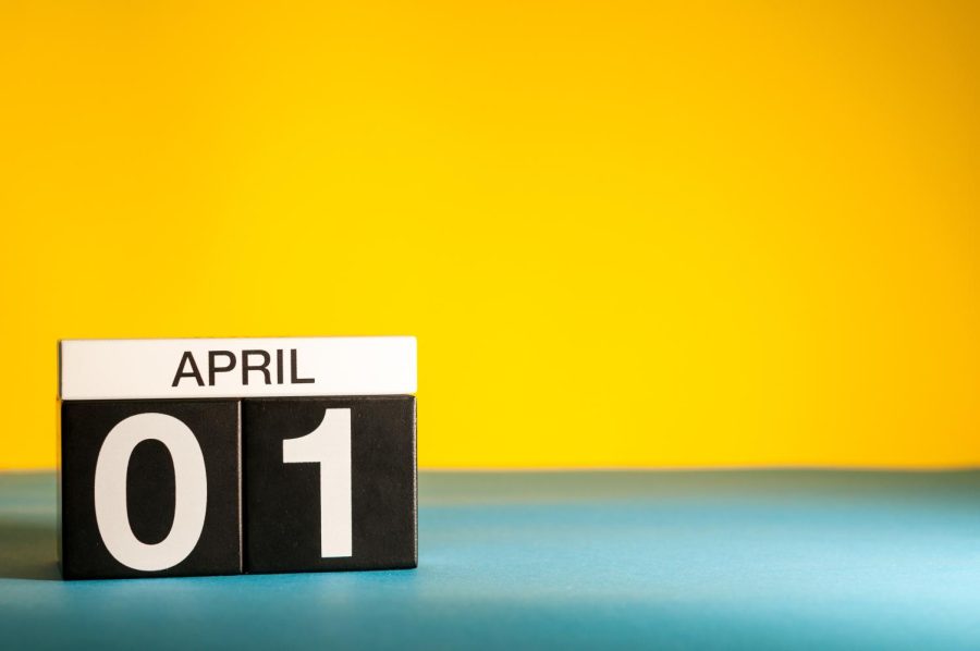 Day 1 of April circled on calendar on table with yellow background (Getty Images)