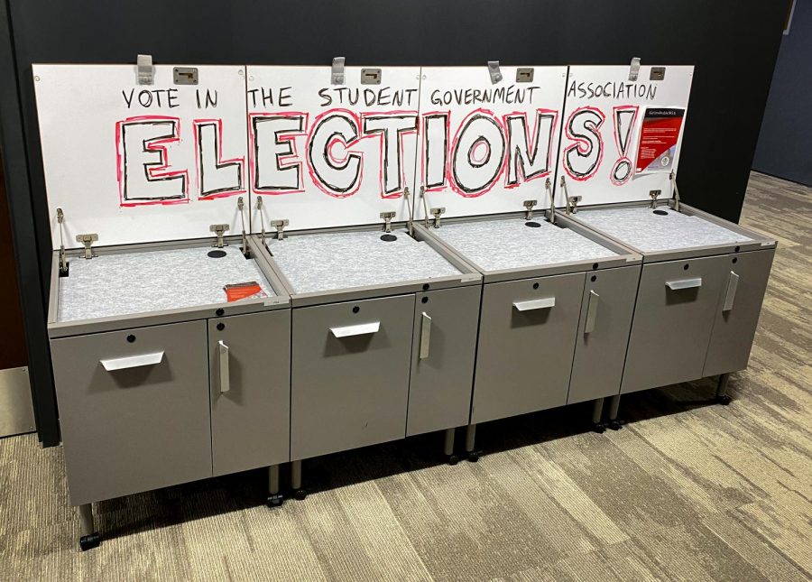 Sign within the SGA OASIS space in the Holmes Student Center promoting for students to vote in the Spring 2022 Student Government Election.