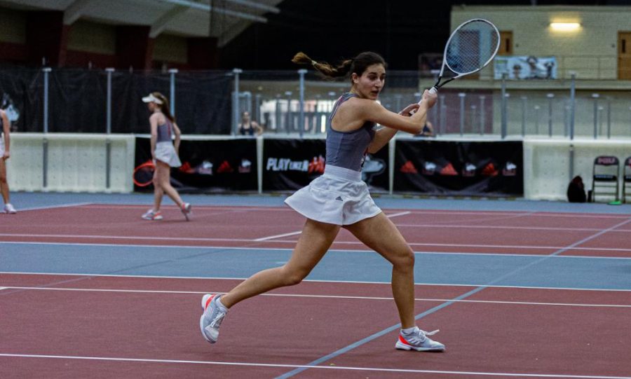 Freshman tennis player Erika Dimitriev swings a racket during practice.