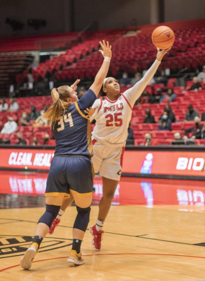NIU junior forward AJah Davis attempts a layup against Toledo freshman forward Jessica Cook during a matchup on Jan. 15 at the Convocation Center in DeKalb. Davis and Cook finished as the leading scorers for their respective squads in their latest matchup on Mar. 3. Davis finished the game with 30 points for the Huskies while Cook recorded 14 points for the Rockets. (Summer Fitzgerald | Northern Star)