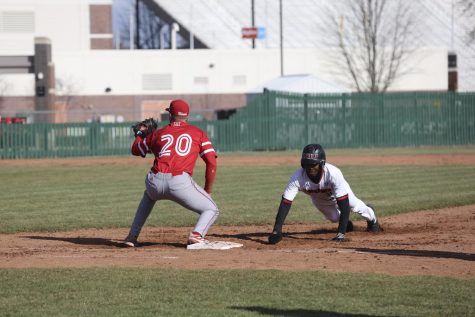 Then-junior outfielder Malik Peters (right) slides to return to first base during a game against Miami University April 1, 2022 in DeKalb.