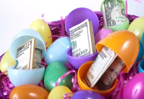 An Easter basket full of eggs with paper money on white background (Getty Images)