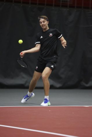 Then-junior tennis player Oliver Valentinsson swing his racket at a tennis ball during a match against Binghamton University April 1, 2022 in DeKalb.