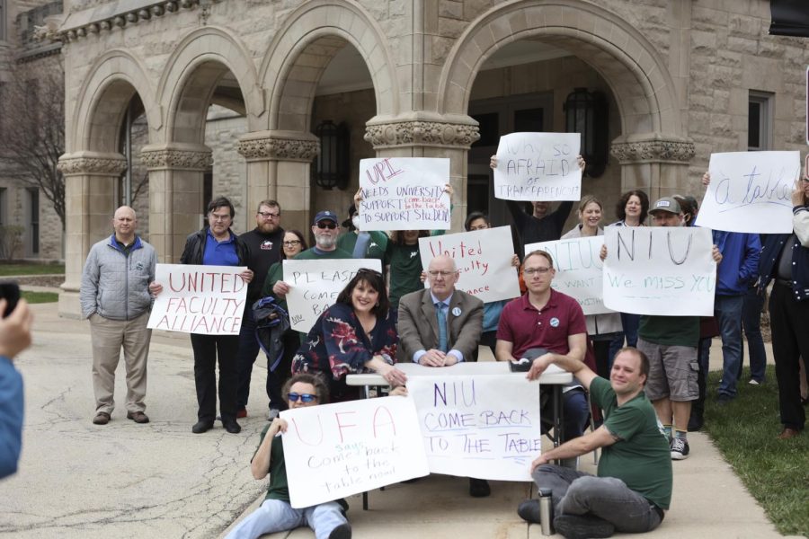 Members+of+UPI+Local+4100%2C+picketing+outside+of+Altgeld+Hall+Wednesday+after+NIU+officials+ceased+negotiations+with+non-tenured+instructors+earlier+this+month+and+have+not+begun+bargaining+talks+with+tenure+faculty.+Members+of+both+non-tenure+and+tenure+gathered+around+a+table%2C+which+signified+the+universitys+absence+from+bargaining+talks.+UPI+Local+4100+represents+members+of+tenured+and+non-tenured+track+faculty+at+NIU%2C+around+750+faculty+are+members+of+UPI%2C+Local+4100.+%28Wes+Sanderson%7C+Northern+Star%29