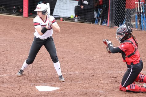 Senior catcher Katie Keller (left) assumes her batting stance during a game against Ball State University April 6 in DeKalb.