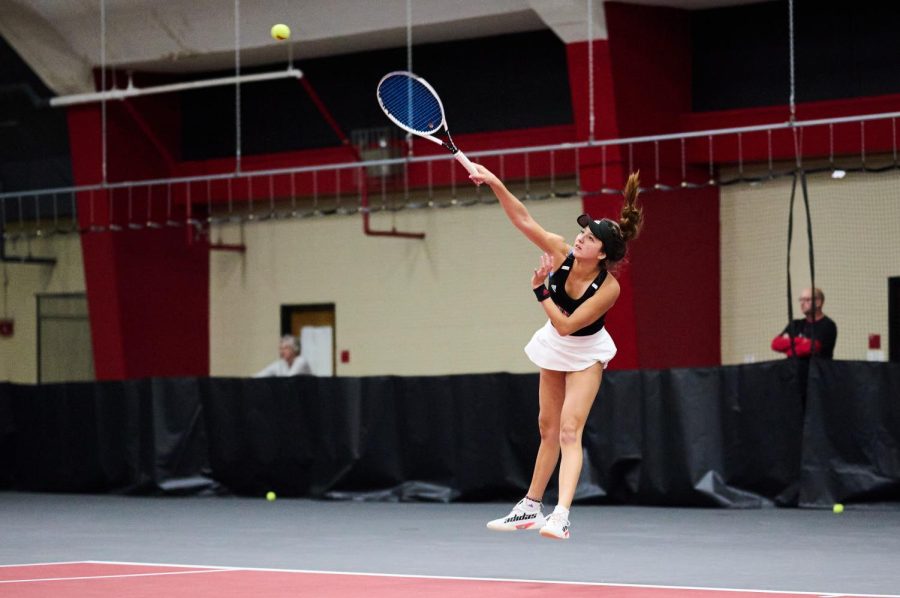 Senior Fernanda Naves hits the ball with an overhand swing during a match against Ball State University Friday in DeKalb.