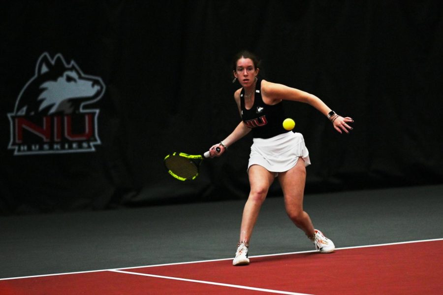Senior Christy Robinson swings her racket during a tennis match against Ball State University on Friday in DeKalb.