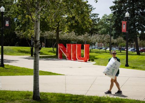 Vicky Books, a kinesiology instructor at NIU, holds up a sign at the protest in the MLK Commons (Sean Reed | Northern Star)