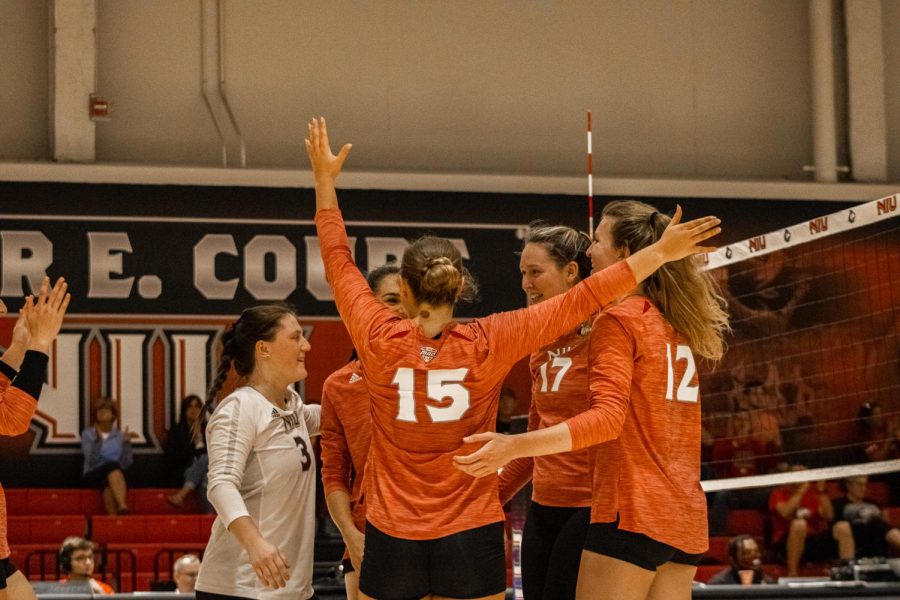(Left to right) Francesca Bertucci, Nikolette Nedic, Ella Mihacevich, Sammi Lockwood and Emily Dykes celebrate a point scored in the second set against SDSU at Victor E. Court on Friday night. (Sean Reed | Northern Star)