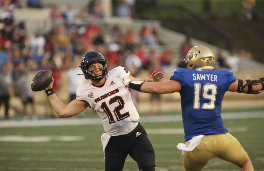 Redshirt senior quarterback Rocky Lombardi evades Tulsa graduate linebacker Grant Sawyer duing a pass attempt in the first half of September 1st 2022 matchup. Lombardi led the Huskie scoring with three touchdowns through the air.