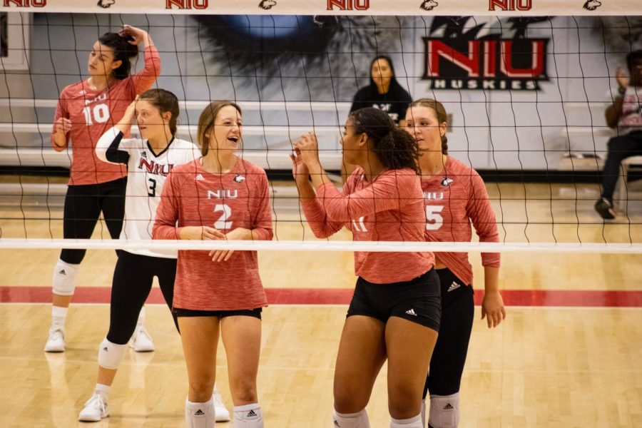 (Left to Right) Francesca Bertucci, Katie Jablonski, Charli Atiemo and  Ella Mihacevich celebrate a kill in the second set of their match against Southern Indiana Saturday afternoon.  (Sean Reed | Northern Star)