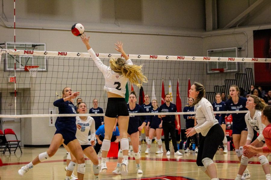 Senior outside hitter Katie Jablonski (Left) performing an attack against opposing University of Rhode Island players. She is supported by Sarah Lezon and Emily Dykes. (Milly Landa | Northern Star)