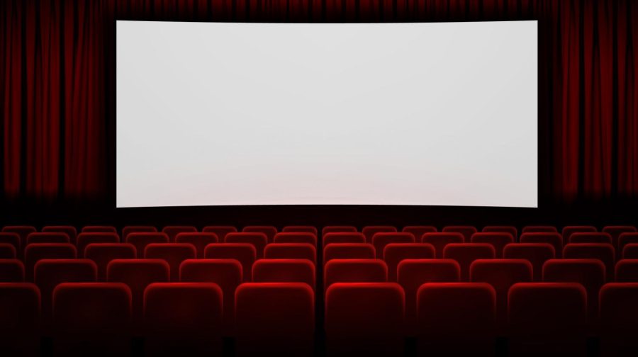 A movie screen with theater seating around it.