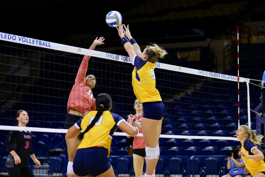 University of Toledo senior middle blocker/opposite hitter Olivia Vance goes up for a block against NIU sophomore middle blocker Charli Atiemos attack during Fridays match between the Huskies and Rockets at Savage Arena in Toledo, Ohio. (Evan Procaccini | Toledo Athletics)
