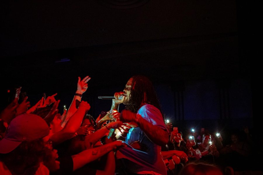 Waka Flocka stands up on the barricade and performs into the crowd Saturday night. (Sean Reed | Northern Star)
