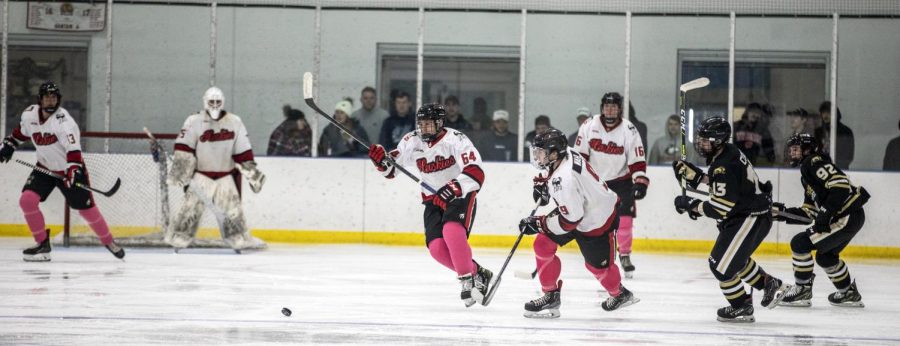 Members of the NIU ice hockey team race to the puck during a home game against the  Purdue University Northwest Pride on Oct. 14. (Beverly Buchinger | NIU Hockey)