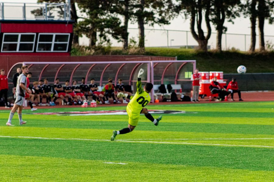 Goalkeep Martin Sanchez punting the ball to Western Michigan’s side of the field during the Huskies match Sunday night at the NIU Soccer & Track and Field Complex. (Marco Sotelo Avila | Northern Star)