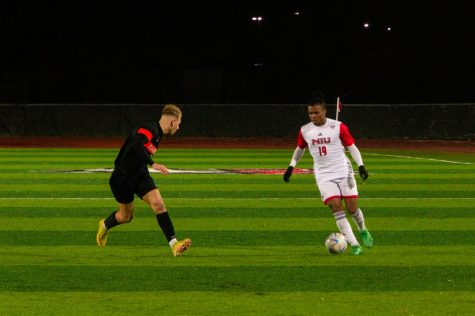 Junior midfielder Eddie Knight (right) nagivates the ball against a BGSU defender during Tuesdays match at the NIU Soccer and Track & Field Complex. (Mingda Wu | Northern Star)