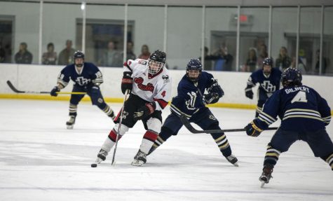 Sophomore defenseman Keaton Peters (4) handles the puck during a game against John Carroll University on Sept. 16 at Canlan Ice Sports in West Dundee. (Beverly Buchinger | NIU Hockey)