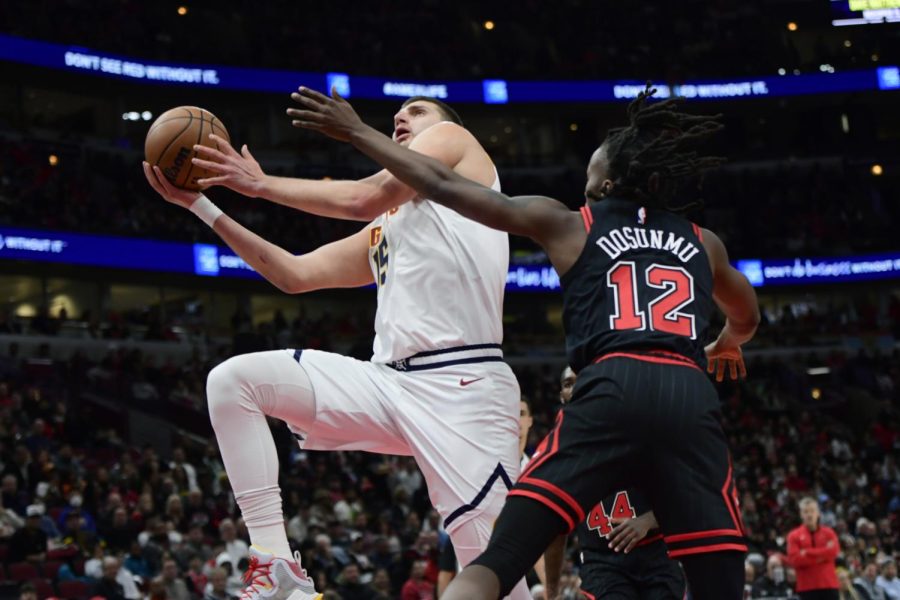 Denver Nuggets center Nikola Jokic (15) goes up to shoot against Chicago Bulls guard Ayo Dosunmu (12) during the first half of an NBA basketball game on Sunday in Chicago. Jokic is the NBAs reigning Most Valuable Players after winning the award for the past two seasons. (AP Photo/Paul Beaty)