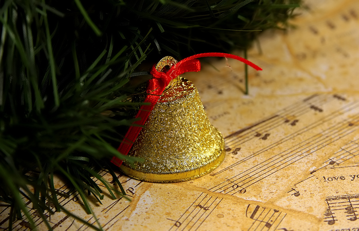 A+bell+shaped+ornament+sits+on+sheet+music.+The+Celebration+Chorale+will+be+performed+at+First+United+Methodist+Church+three+times+in+the+next+week.+%28Courtesy+of+Getty+Images%29