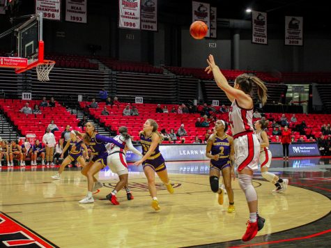 NIU graduate forward Emma Carter shoots a three-pointer near the end of the first half of the Huskies Thursday game at the Convocation Center. (Nyla Owens | Northern Star)