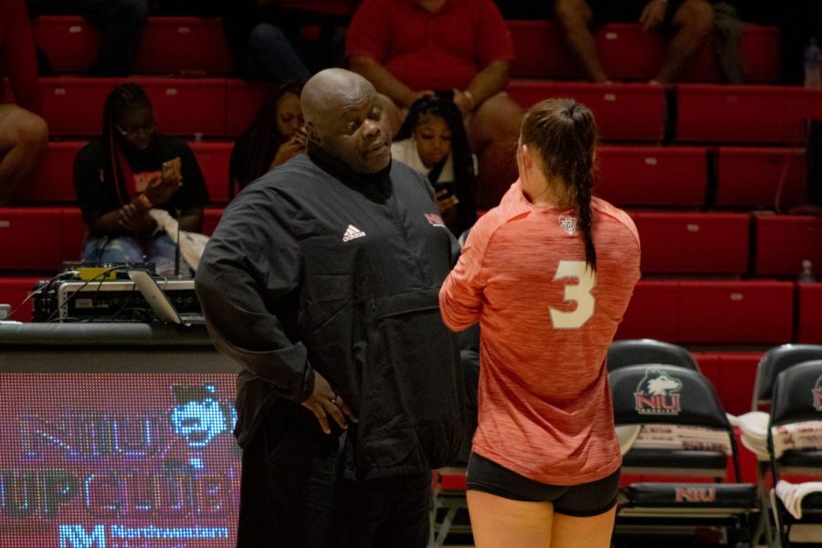 NIU head volleyball coach Ray Gooden speaks with sophomore libero Francesca Bertucci between rallies in the Huskies’ first regular season game against the New Jersey Institute of Technology on Aug. 26. (Sean Reed | Northern Star)