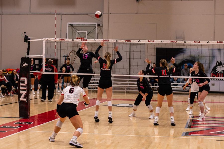 Junior middle blocker Sammi Lockwood (left) attempts to block a kill from Ball State University’s junior outside hitter Cait Snyder during the Oct. 15 match. (Alyssa Queen | Northern Star)