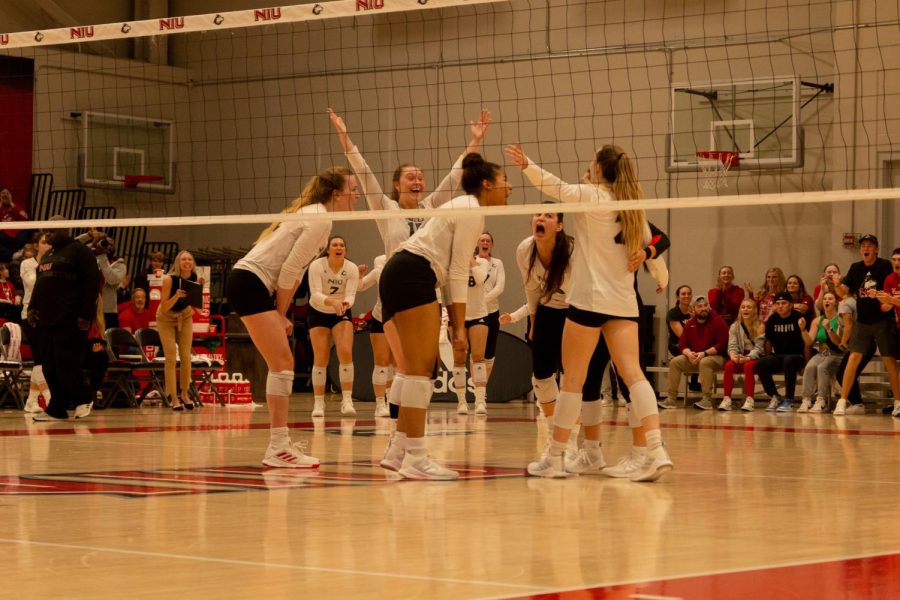 The huskies celebrating a point on the court against Central Michigan University on Friday at Victor E. Court. (Mingda Wu | Northern Star)