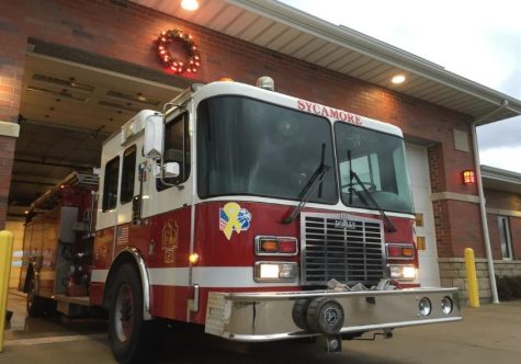 A Sycamore fire engine rests part-way out of the garage as one of the holiday wreaths hangs above at a Sycamore fire station. (Courtesy of Sycamore Fire Department)