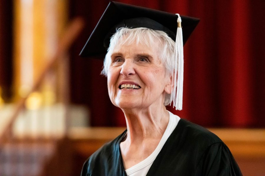 Joyce DeFauw tries on a graduation cap during a visit to the NIU campus in August.