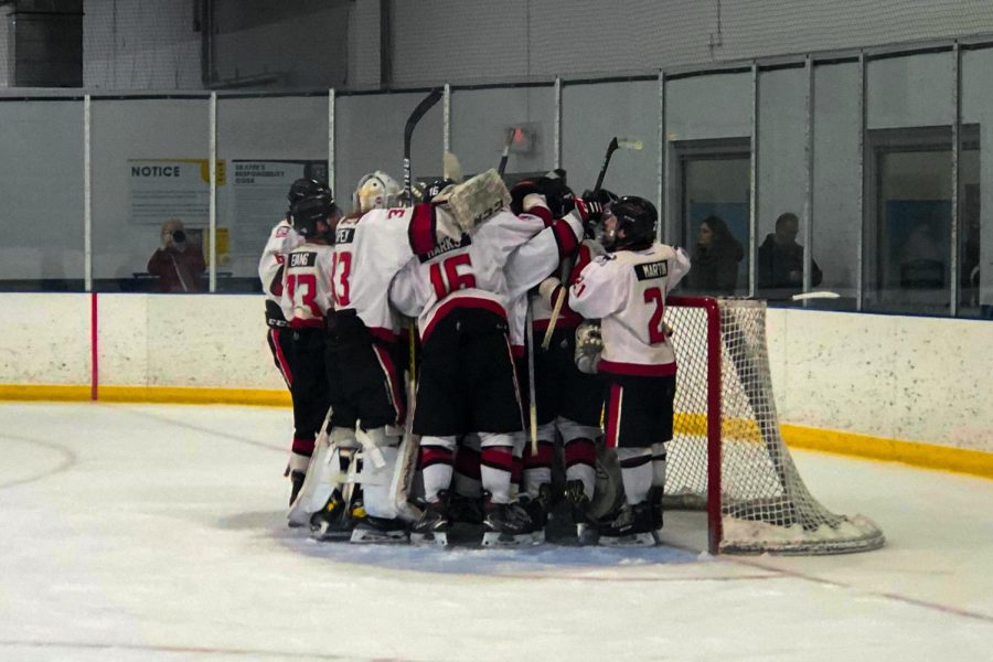 Players from NIU hockey celebrate around their goal moments after securing their first win of the season on Saturday. NIU defeated McKendree 5-3, splitting the weekend series. (Skyler Kisellus | Northern Star)