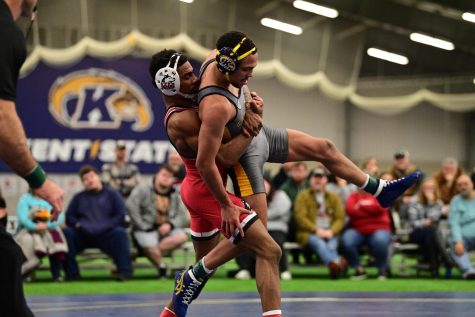 NIU redshirt junior Jaivon Jones wraps up Kent State University redshirt junior Louis Newell during the 141 match Sunday. Jones defeated Newell in a 3-1 decision to give NIU its first points of the dual. (David Dermer)