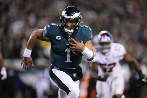 Philadelphia Eagles quarterback Jalen Hurts runs for a touchdown against the New York Giants during the first half of an NFL divisional round playoff football game, Saturday, Jan. 21, 2023, in Philadelphia. (Matt Rourke | Associated Press)