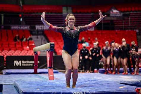 Then-sophomore gymnast Kendall George completes her beam attempt during a dual meet against Illinois State University on Feb. 13 at the NIU Convocation Center in DeKalb, Ill. (Northern Star File Photo)