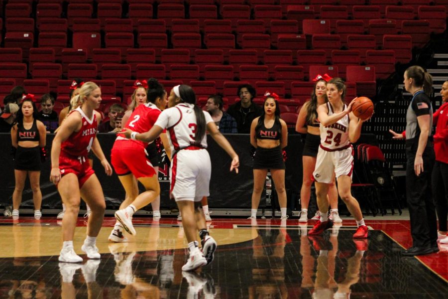 NIU graduate forward Emma Carter (24) looks for a pass during the Huskies’ home basketball game against Mid-American Conference rival Miami University at the NIU Convocation Center. (Nyla Owens | Northern Star)