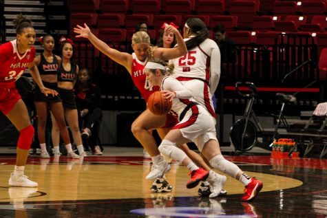 NIU senior guard Chelby Koker (10) controls the ball against Miami University sophomore guard Ivy Wolf (4) during Wednesday’s women’s basketball game at the Convocation Center in DeKalb. (Nyla Owens | Northern Star)