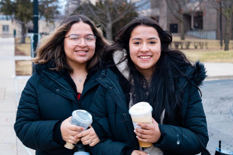 Stephanie Almanza (left) visits with Ezmeralda Almanza, a first year student political science major at NIU, drinking coffee and walking through MLK Commons. (Cheyanne Quintanilla | Northern Star)