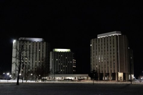 The southern Grant Towers sit vacant on Saturday night as the northern Towers light up the surrounding parts of campus. The Grant Towers were built between 1965 and 1966, with the southern Towers most recently having been used for COVID-19 surveillance testing. (Sean Reed | Northern Star)