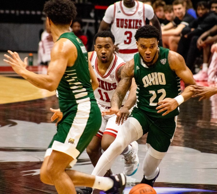 Huskies sophomore guard David Coit (11) rushes for the ball behind Ohio University’s senior guard DeVon Baker (22) during the Huskies’ matchup against the Ohio Bobcats on Tuesday night at the NIU Convocation Center. (Tim Dodge | Northern Star)