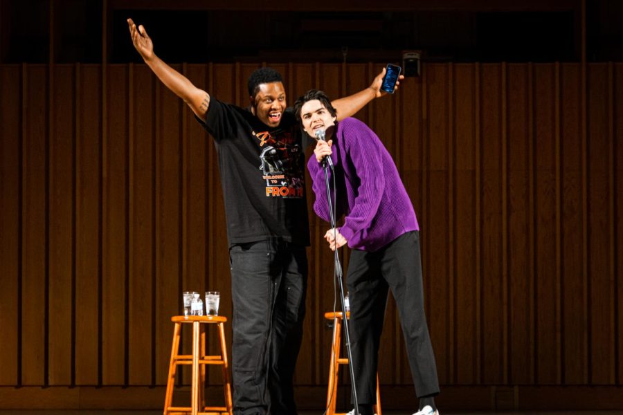 Comedians and Saturday Night Live cast members Devon Walker (left) and Michael Longfellow (right) receiving applause from NIU students after entering stage at the beginning of the show on Wednesday night at Boutell Memorial Concert Hall in the Music Building. (Mingda Wu | Northern Star)