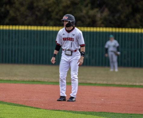 Junior infielder Andre Demetral (1) leads off first base during NIU baseballs home opener against Ohio on March 24. The Huskies lost the game by a final score of 11-2. (Tim Dodge | Northern Star)