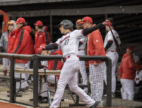 Junior infielder and outfielder Andrew Smart (27) takes a practice swing while on-deck during NIU Baseballs home opener for the season. (Tim Dodge | Northern Star)